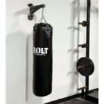 Bolt Strength 4ft Boxing Bag hanging against white wall