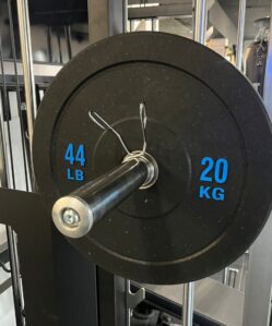 Flecked bumper plate 20KG on a bar